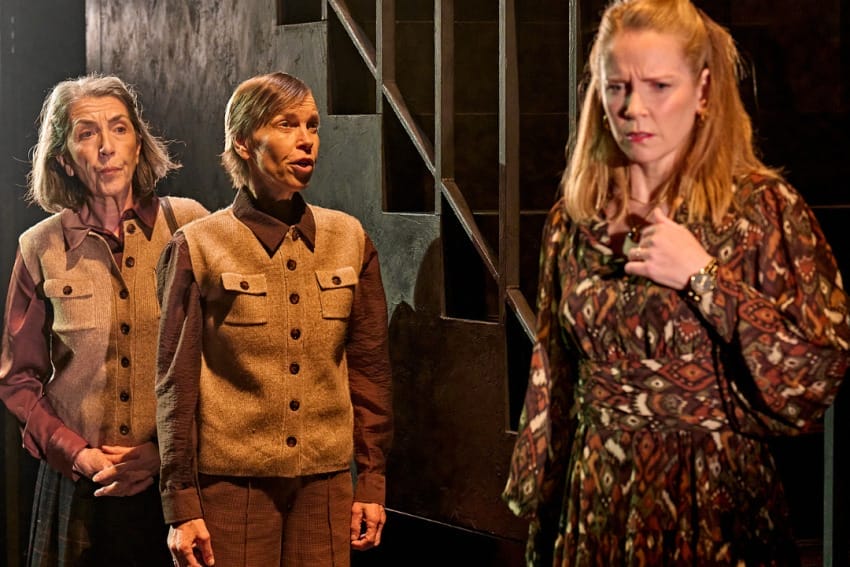 A production image from ‘Don’t Look Now.’ Laura expresses a sad emotion, holding one hand towards her chest. She has seemingly been told some sad or worrying news from the sisters, who stand to the left of her.